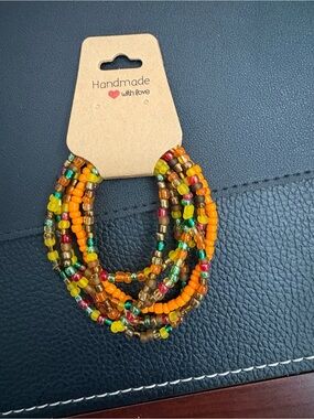 Handmade Multicolor Seed Bead Bracelet with Orange Accents
